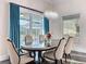 Elegant dining room with a chandelier, table for six, and a view of the pool area at 5603 Tybee Island Dr, Apollo Beach, FL 33572