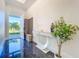 Inviting foyer with glossy marble floors, modern console table, and a glimpse of the outdoors at 5603 Tybee Island Dr, Apollo Beach, FL 33572