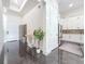 Bright foyer featuring marble floors, a modern console table, and a glimpse into the adjacent kitchen at 5603 Tybee Island Dr, Apollo Beach, FL 33572