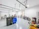 Spacious garage with epoxy flooring, ample storage, and room for multiple cars and recreational equipment at 5603 Tybee Island Dr, Apollo Beach, FL 33572
