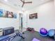 Brightly lit home gym with rubber flooring, workout equipment, and a wall-mounted TV for easy exercise at 5603 Tybee Island Dr, Apollo Beach, FL 33572