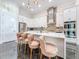 Open-concept kitchen features a large center island with bar stool seating, stainless steel appliances, and sleek white cabinets at 5603 Tybee Island Dr, Apollo Beach, FL 33572