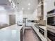 Modern kitchen boasts stainless steel appliances, sleek white cabinetry, and a spacious island at 5603 Tybee Island Dr, Apollo Beach, FL 33572
