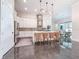 Spacious kitchen boasts white cabinets, stainless steel appliances, large island with barstool seating, and modern finishes at 5603 Tybee Island Dr, Apollo Beach, FL 33572