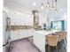 A gourmet kitchen boasts stainless appliances, a large island, pendant lights, and ample white cabinets at 5603 Tybee Island Dr, Apollo Beach, FL 33572