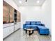 Relaxing living room with decorative cabinet, a plush blue couch, and a modern coffee table in a serene setting at 5603 Tybee Island Dr, Apollo Beach, FL 33572