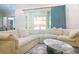 Comfortable living room with sectional seating and a view to a screened in outdoor space at 5603 Tybee Island Dr, Apollo Beach, FL 33572