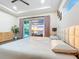 Serene main bedroom with a plush bed, stylish décor, and an outdoor view for a relaxing ambiance at 5603 Tybee Island Dr, Apollo Beach, FL 33572