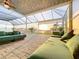 Inviting outdoor seating area with plush green cushions and serene water views at sunset at 5603 Tybee Island Dr, Apollo Beach, FL 33572