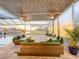 Covered patio with ceiling fans and ample seating, overlooking a pool and a picturesque canal at sunset at 5603 Tybee Island Dr, Apollo Beach, FL 33572