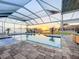 Screened-in pool area with a relaxing view of the canal, perfect for enjoying the sunset at 5603 Tybee Island Dr, Apollo Beach, FL 33572