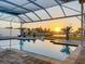 Screened-in pool overlooking the canal, creating a serene atmosphere for relaxation and sunset views at 5603 Tybee Island Dr, Apollo Beach, FL 33572