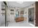 Bathroom featuring a wooden vanity, a window, and a tub-shower combo at 588 Bayview Dr, Longboat Key, FL 34228