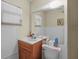 Cozy bathroom featuring a vanity, toilet, mirror, and window for natural light at 588 Bayview Dr, Longboat Key, FL 34228