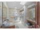 Well-lit bathroom with a skylight, floral wallpaper, and a shower-tub combination at 588 Bayview Dr, Longboat Key, FL 34228