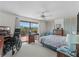 Bright bedroom featuring a ceiling fan, a desk, and an access to a private balcony at 588 Bayview Dr, Longboat Key, FL 34228