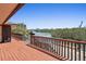 Relaxing wooden deck with railing offers picturesque views of the serene waterway at 588 Bayview Dr, Longboat Key, FL 34228
