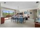 Elegant dining room with large windows offering scenic views and a classic chandelier at 588 Bayview Dr, Longboat Key, FL 34228
