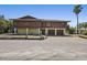 Two-story home with brown wood paneling, two-car garage, and well-maintained lawn at 588 Bayview Dr, Longboat Key, FL 34228