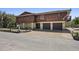 Two-story home with brown wood paneling, two-car garage, and well-maintained lawn at 588 Bayview Dr, Longboat Key, FL 34228