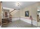 Foyer with tile flooring, staircase, and wainscoting leading to other parts of the home at 588 Bayview Dr, Longboat Key, FL 34228