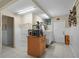 Functional laundry room with washer, dryer, storage cabinets, and tile flooring at 588 Bayview Dr, Longboat Key, FL 34228