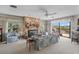 Cozy living room featuring a stone fireplace, plush seating, and sliding doors to the outdoor deck at 588 Bayview Dr, Longboat Key, FL 34228