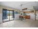 Versatile living space featuring a kitchenette, sliding glass door, and tile flooring at 588 Bayview Dr, Longboat Key, FL 34228