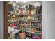 Walk-in pantry with plenty of storage shelves at 588 Bayview Dr, Longboat Key, FL 34228