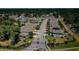 Aerial view of a neighborhood showcasing well-maintained homes, tree-lined streets, and community entrance at 5928 81St N Ave, Pinellas Park, FL 33781