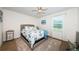 Bright bedroom featuring neutral walls, ceiling fan, large window, and a queen bed at 5928 81St N Ave, Pinellas Park, FL 33781