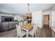 Open-concept dining area features modern light fixture and flows into the living room and kitchen at 5928 81St N Ave, Pinellas Park, FL 33781