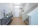Bright entryway featuring tile floors, a staircase, console table with decor, and neutral walls at 5928 81St N Ave, Pinellas Park, FL 33781