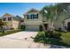 Charming two-story home with a well-maintained lawn, a palm tree and neutral color scheme at 5928 81St N Ave, Pinellas Park, FL 33781