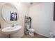 Charming half bathroom with pedestal sink, decorative mirror, and modern fixtures at 5928 81St N Ave, Pinellas Park, FL 33781
