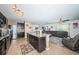 Open-concept kitchen with black cabinetry, stainless steel appliances, and a granite-topped island at 5928 81St N Ave, Pinellas Park, FL 33781