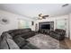 Cozy living room with an entertainment center, plush sectional sofa, area rug, and bright windows at 5928 81St N Ave, Pinellas Park, FL 33781