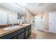 Main bathroom featuring double sinks, granite countertops, and glass-door shower at 5928 81St N Ave, Pinellas Park, FL 33781