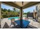 Outdoor patio area with seating, a ceiling fan, and a view of the private pool and landscaping at 5928 81St N Ave, Pinellas Park, FL 33781