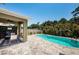Backyard with a private in-ground pool, patio area, privacy fence, and lush tropical landscaping at 5928 81St N Ave, Pinellas Park, FL 33781
