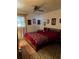 Bedroom featuring a maroon comforter with an elaborate design and a ceiling fan at 5940 21St N St # 11, St Petersburg, FL 33714