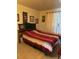Bright bedroom with a striped comforter, light wood floors and natural light from the nearby window at 5940 21St N St # 11, St Petersburg, FL 33714