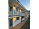Well-lit two-story building exterior featuring walkways, balconies, and exterior lighting at 5940 21St N St # 11, St Petersburg, FL 33714