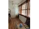 Cozy living room featuring laminate wood floors, large windows with curtains, and comfortable seating area at 5940 21St N St # 11, St Petersburg, FL 33714