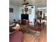 Living room features wood flooring, area rug, ceiling fan and entry into the dining room at 5940 21St N St # 11, St Petersburg, FL 33714