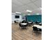 A functional meeting space equipped with tables, chairs, and a wall-mounted TV at 5940 21St N St # 11, St Petersburg, FL 33714