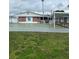 Exterior view of the recreation hall, an American flag and shuffleboard courts at 5940 21St N St # 11, St Petersburg, FL 33714
