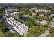 Community aerial view showcasing its lush green landscaping, serene lake, sparkling pool, and surrounding neighborhood at 6070 80Th N St # 308, St Petersburg, FL 33709