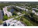 Stunning aerial view of the community featuring a pool, lake, green landscaping, and the complex buildings at 6070 80Th N St # 308, St Petersburg, FL 33709