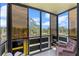 Enclosed balcony offering a serene view of a lake and surrounding trees at 6070 80Th N St # 308, St Petersburg, FL 33709